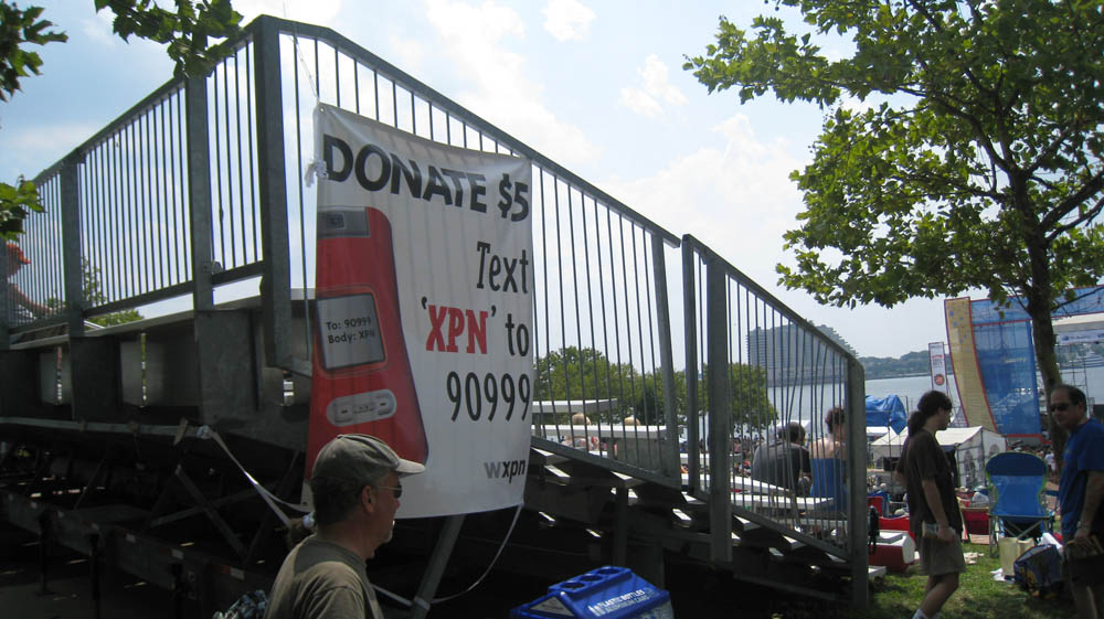 Poster encouraging donations to WXPN hanging on bleachers