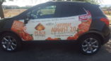 Peach festival advertisement on a car
