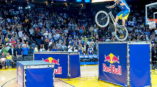 Biker jumping over Red Bull banners at Oracle Arena