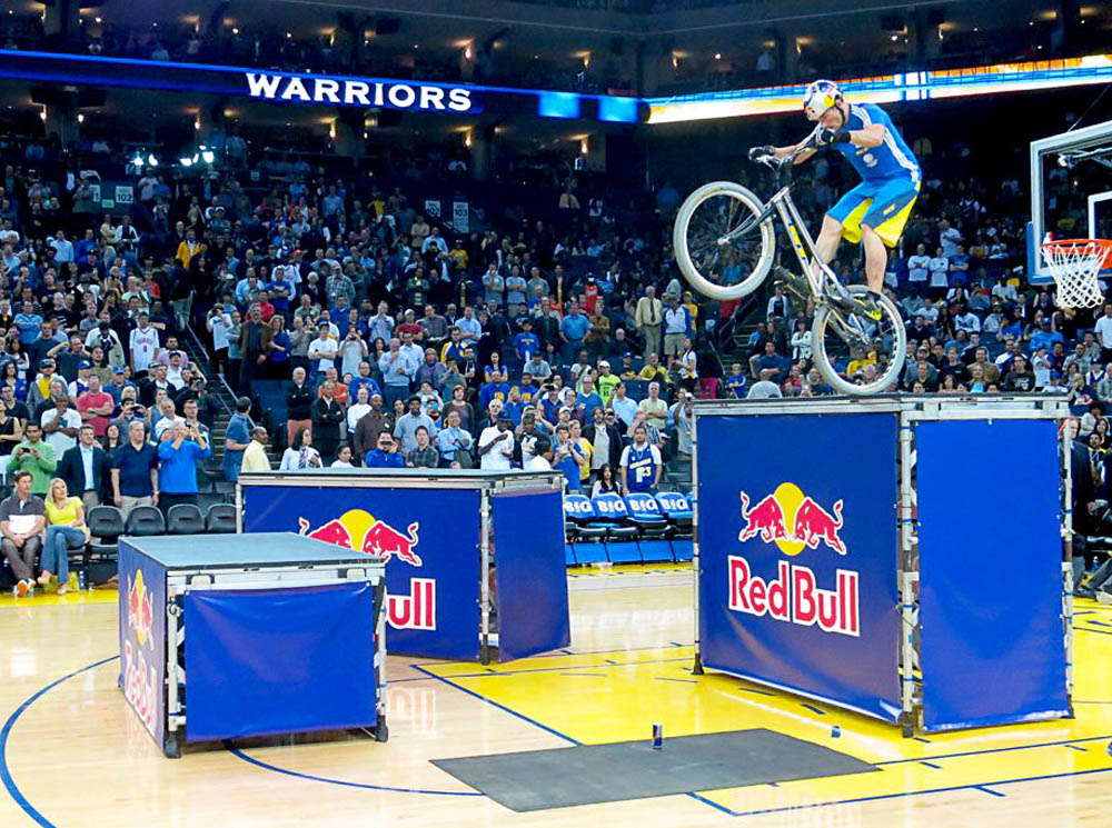 Biker jumping over Red Bull banners at Oracle Arena