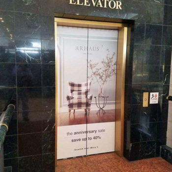 Center Court elevator with wrap of Arhaus advertisement