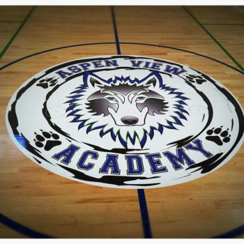 Floor graphic of Aspen View Academy logo on basketball court