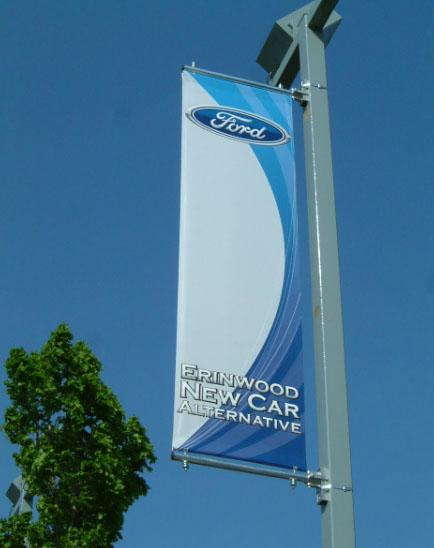 Erinwood New Car Alternative banner on a light post