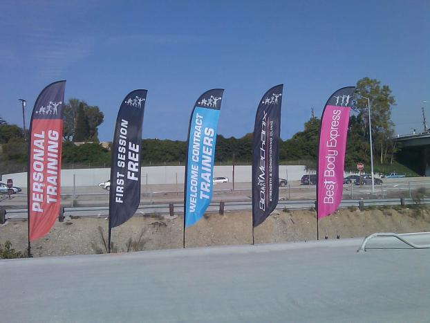 Personal training flag banners on the side of the road