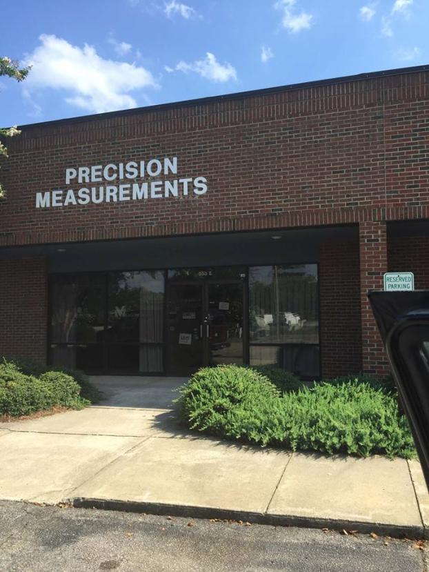 Precision Measurements sign on brick building