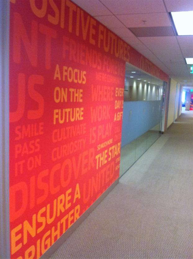 Wall graphic of words centered around positivity