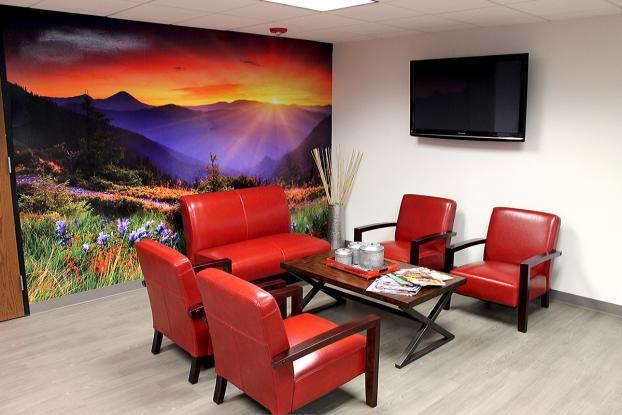 Full wall mural of a sunset over mountains in an office lobby