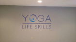 Yoga Life Skills logo on wall
