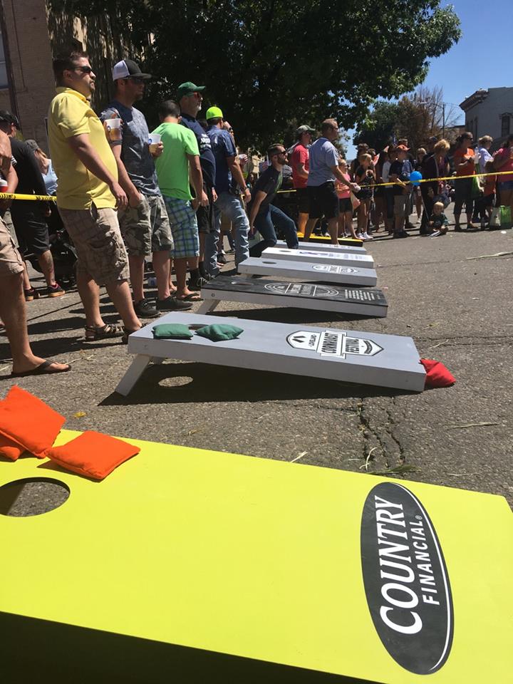 Group of people playing corn hole.