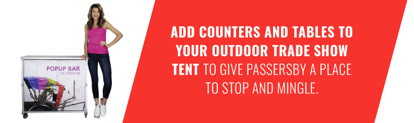 Add counters and tables to your outdoor trade show tent to give passersby a place to stop and mingle.