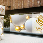 White and gold balls on two signs for Amore Diamonds & Fine Jewelry in gold. 