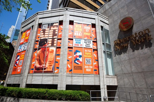 Large format window graphics in orange printed on a hexagonal building