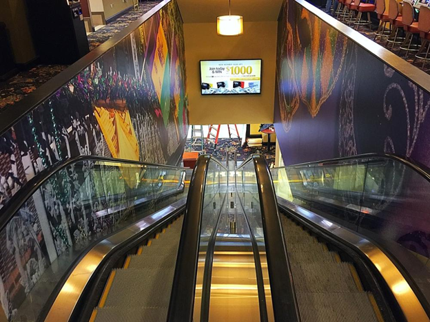 Branded escalator walls with large format printed graphics